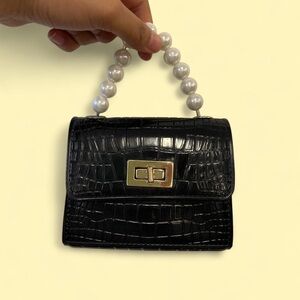 Black faux leather mini purse with pearl chain strap